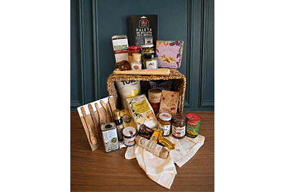 Custom bespoke gourmet gift basket displayed against an elegant teal background