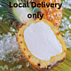 A beautifully presented Bindi Pineapple Ripieno dessert, served in a hollowed-out pineapple shell, filled with smooth and creamy pineapple sorbet, garnished with a fresh pineapple wedge for a tropical and refreshing treat."