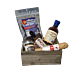A wooden crate filled with a selection of spicy foods including ghost pepper salami, scorpion pepper chocolate, ghost salt, reaper miso, blueberry ghost barbecue sauce, and reaper hot sauce, all set against a rustic wooden background.